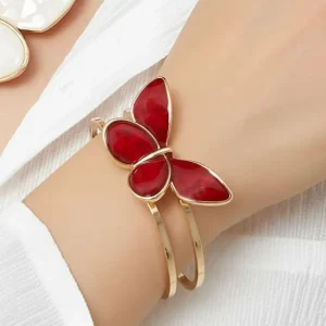 On Hand Belle Miss ALBINENN rigid bracelet with golden structure and large red butterfly motif made of resin. Jewelry gift Cyprus.