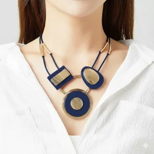 Woman wears Belle Miss EMILIEN necklace with gold metal pattern and navy blue acrylic plate on a leather cord. Jewelry gift Cyprus
