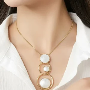 Woman wearing Belle Miss IBRAME golden necklace made of colored mother-of-pearl. Ideal jewelry gift for women in Cyprus.