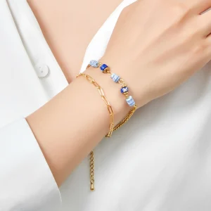Woman Wears VANA 2-row bracelet, gold-plated steel, composed of natural blue stones and mother-of-pearl. Layered chain bracelet gift Cyprus