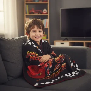 Kids Lightning McQueen Blanket (100x150cm) - Bedding & Gifts in Cyprus- Boy sits with the blanket