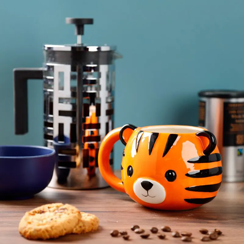 adoramals-tiger-head-ceramic-shaped-mug-700ml-6 Bold tiger-shaped 700ml mug used for a morning beverage in a modern kitchen.