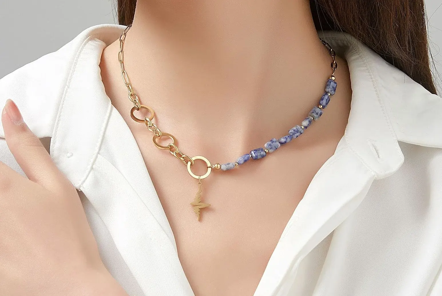 Woman Wears Ursina Gold-Plated Steel Chain Necklace with Lightning Bolt Motif & Blue/Black Natural Stones Blue